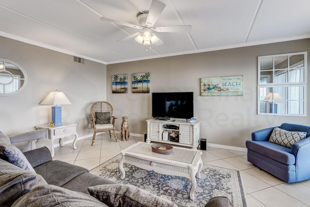 Coast View Condo Featuring Large Windows Overlooking the Beach by RedAwning